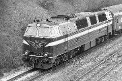DSB MZ 1405 (type I) photographed in Fredericia - heading for Vejle. 15. January 1978. The MZ class (type I and II) was purchased from 1967 to 1970 in a number of 26. Only a few of these engines remain in service by DSB - most are now sold to other companies. Built by NOHAB and Frichs. Dieselelectric. Co'Co'. 2270 kW - 3300 hp. Max speed 143 km/h - 89 mph. Length 20 800 mm. Weight 116,5 metric tonnes. MZ 1405 was put in service in 1968. From 2001 to 2002 leased to Railion. In 2002 sold to Banestyrelsen. In 2004 sold to Three T in Sweden.
